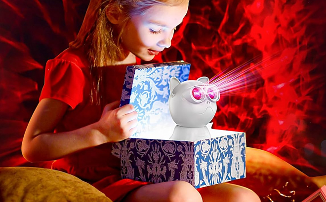 A Girl Holding a Box with the Pedica Dog Galaxy Projector Inside