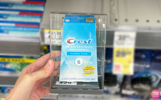 A Person Holding a Crest At Home Teeth Whitening Starter Kit
