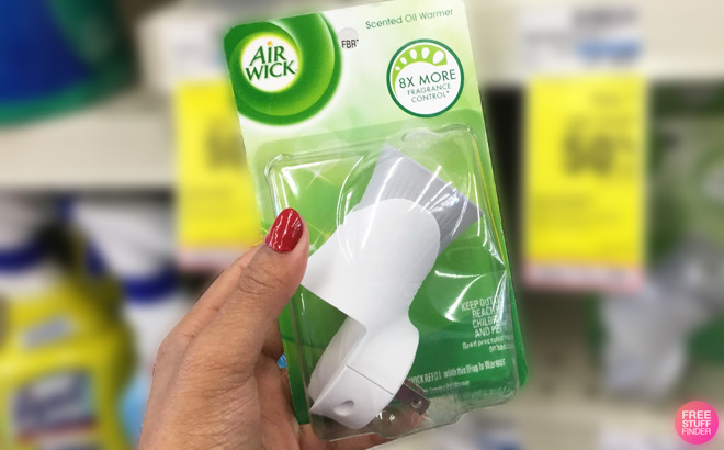 A Person Holding Air Wick Scented Oil Air Freshener Warmer