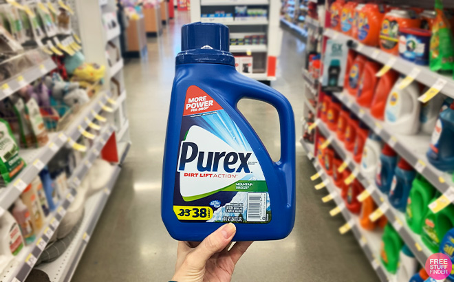 A Person Holding Purex Laundry Detergent Mountain Breeze in a Store Aisle