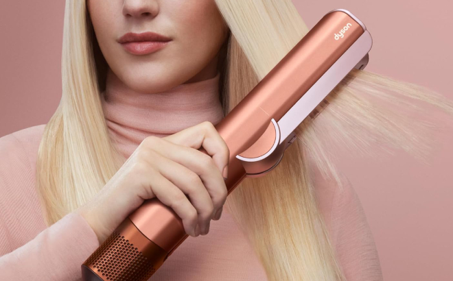 A Person Using a Dyson Airstrait Wet to Dry Hair Straightener