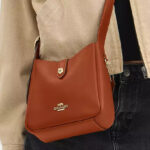 A Person Wearing Coach Outlet Hadley Mini Crossbody Bag in Smooth Leather Color