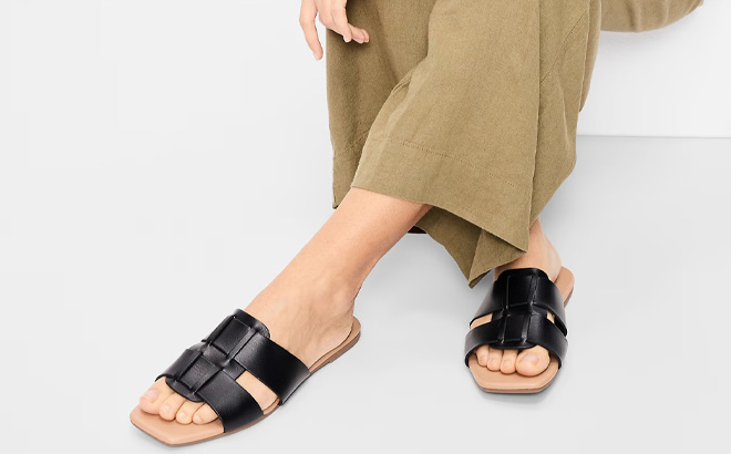 A Person Wearing Old Navy Faux Leather Slide Sandals in Black Jack Color
