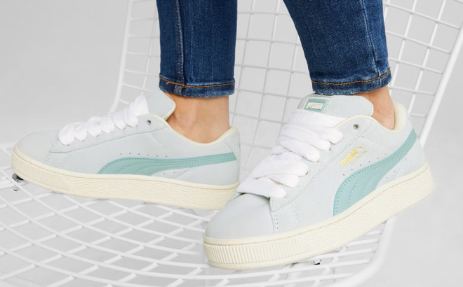 A Person Wearing Puma Suede XL Athletic Shoes