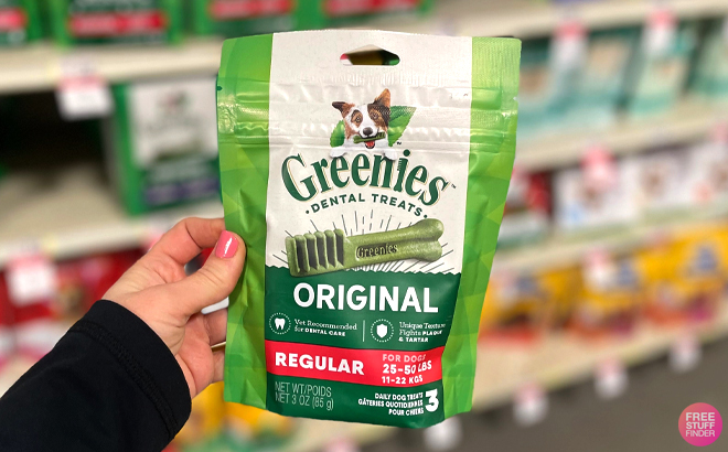 A Woman Holding a Bag of Greenies Dog Dental Treats