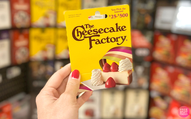 A Woman Holding The Cheesecake Factory Gift Card