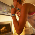 A Woman Using Apple Fitness App to Work Out at Home