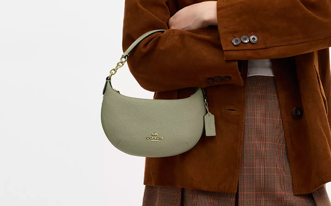 A Woman Wearing Coach Outlet Mini Payton Bag in Pistachio