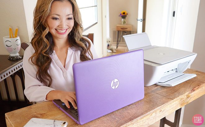 Woman Typing on a Purple HP Laptop 