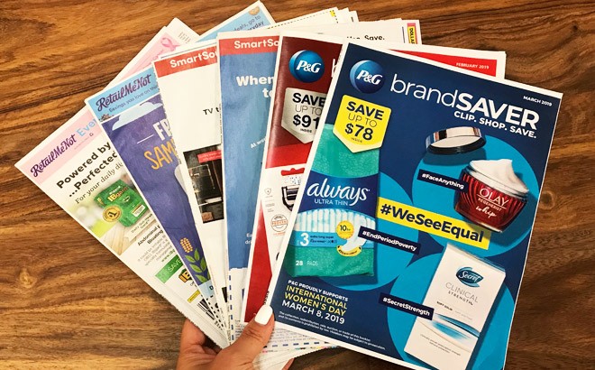 A Hand Holding Coupon Inserts A Hand Holding Coupon Inserts