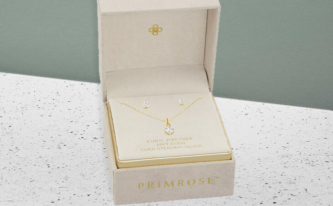 PRIMROSE 18k Gold Over Silver Cubic Zirconia Pendant Necklace Stud Earring Set on the Table